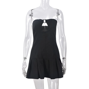 Détail d'une robe bustier noire courte avec découpe poitrine et boucle métallique