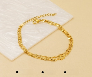 Detail of 18K gold plated double-layer stainless steel bracelet with Hamsa Hand pendant