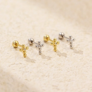 Macro shot of S925 silver cross stud earrings with sparkling zircon and screw backs
