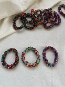 Detailed macro shot of multicolor faceted crystal beads on an elastic hair tie