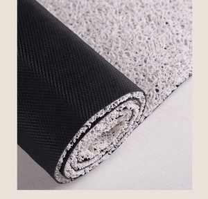 Detail of grey silk loop entryway mat showing flexible material and anti-slip backing