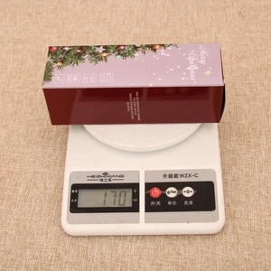 Detail showing Christmas lantern weight of 170g on a scale for shipping and size reference