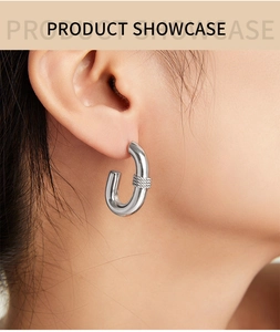 Detail shot of silver U-shaped hoop earring featuring a classic twisted rope texture