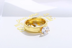 Macro detail of 6mm round zircon prong setting on a gold titanium steel ring