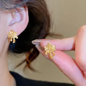 Elegant gold-plated sunburst flower earrings with vintage French style and brushed metal texture