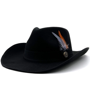 Black western felt cowboy hat with vintage metal badge and orange feather accent