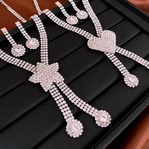 Macro detail of silver heart and star pendant sets with sparkling rhinestone tassels