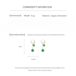 Detail specifications of gold drop earrings with green rhinestones and tassel accents
