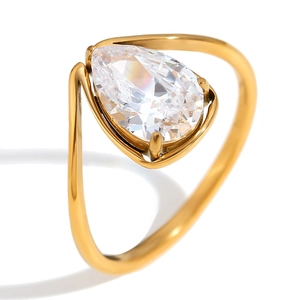 18K gold plated stainless steel ring with pear cut white cubic zirconia on white background