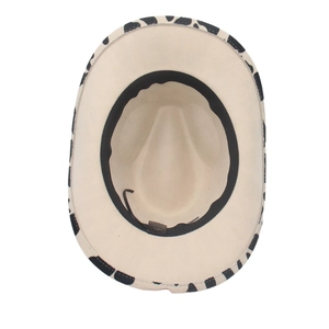 Overhead view of a western cowboy hat with cow print brim and soft felt interior