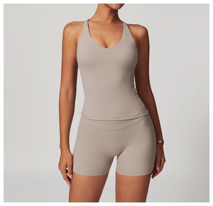 Front view of a V-neck cross back yoga tank top and high-waist shorts in taupe brushed fabric