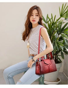 Model wearing a red crocodile pattern tote bag shown as a stylish shoulder bag