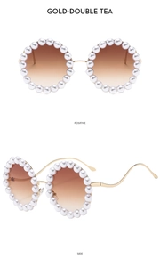Detailed view of round gold sunglasses with pearl-encrusted frames and wavy temples