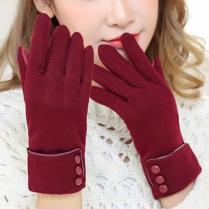 Close-up of wine red thermal gloves with elegant three-button detail on the wrist cuff