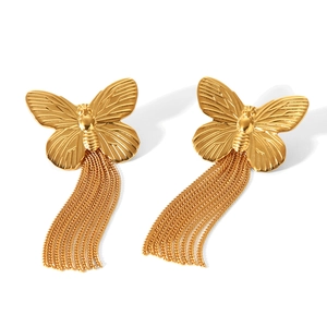 Detailed view of gold butterfly tassel earrings with polished finish and dangling chains