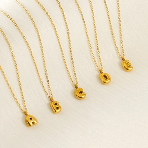Golden bubble letter necklaces with A, B, C, D, E alphabet pendants on elegant link chains