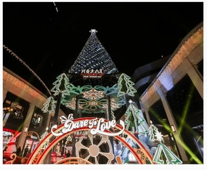 Night view of a giant Christmas tree installation with HKRI TAIKOO HUI holiday decorations