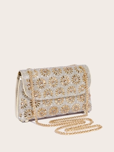 Macro detail of luxury gold evening clutch with sunflower rhinestone and gemstone patterns