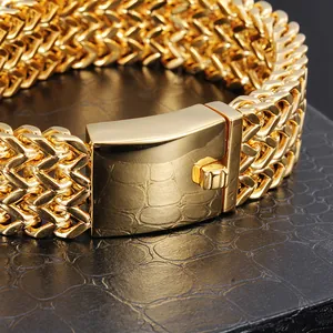 Close-up of gold stainless steel men's bracelet with fish scale pattern and square clasp.
