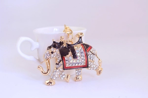 Detailed view of a gold elephant keychain with sparkling rhinestones and enamel accents