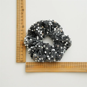 Grey velvet sequin hair scrunchie with measuring ruler for 10cm diameter reference