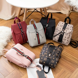 Mini floral leather backpack collection in multiple colors shown on a stylish wooden floor