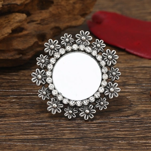 Detailed close-up of bohemian silver flower ring with inlaid rhinestones on wood