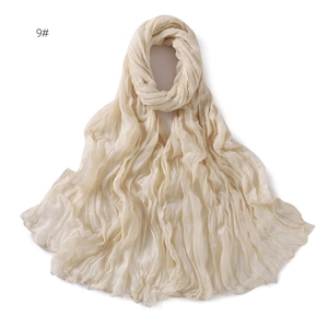 Detailed view of cream voile pleated scarf texture with lightweight breathable fabric