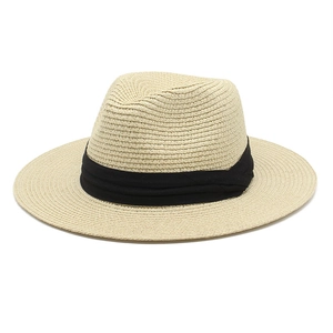 Classic beige Panama straw hat with black ribbon band for sun protection on white background