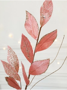 Detailed view of pink velvet Christmas leaves with sparkling gold glitter accents