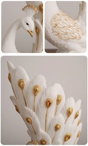 Macro detail of white peacock vase featuring relief golden spots and feather textures