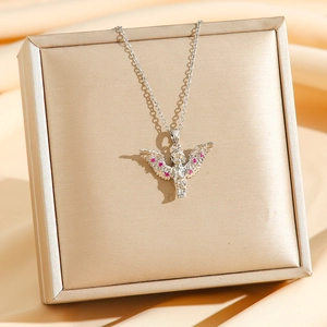 Elegant silver angel necklace with pink stones on silk fabric in a luxury gift box