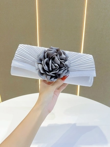 Grey pleated evening clutch with large flower detail, elegant design for parties and banquets.