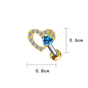 Close-up of heart-shaped gold earring with blue zircon and white diamonds inlay