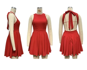 Detail of red halter neck dress featuring an open back with a decorative bow tie design