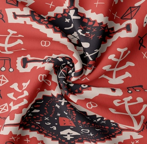 Detail of bohemian tribal print fabric with red black and white geometric patterns