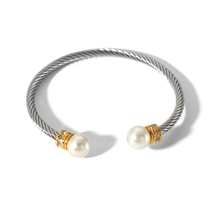 Detail of twisted cable stainless steel bracelet with white pearls and sparkling crystals