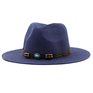 Detail view of woven straw hat with wooden beads and turquoise stone decorative band