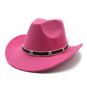 Close-up of hot pink felt cowboy hat with brown faux leather band and white cord