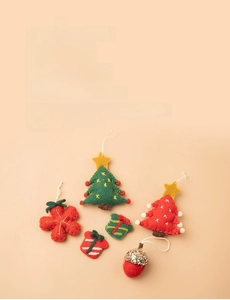 Flat lay of wool felt Christmas ornaments including trees, snowflake and pinecone