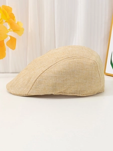 Detail view of beige linen flat cap with breathable straw-like texture and retro style