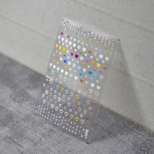 Detail shot of laser holographic heart nail stickers with metallic reflective patterns