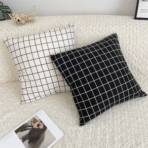 Detail showing high-quality cotton linen fabric texture on black and white grid pillowcase