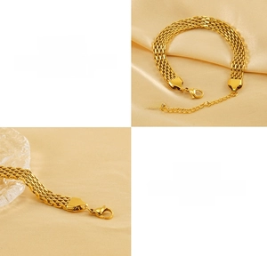Close-up of golden braided stainless steel bracelet with 18K tag and lobster clasp