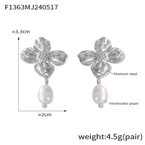 Detail of titanium steel floral earrings with water-drop freshwater pearl pendants