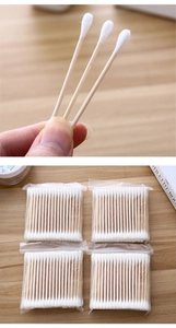 Detail of disposable wooden cotton swabs with dual tips in portable four-pack packaging