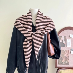 Detail shot of a knotted pink and brown striped wool blend knitted triangular scarf
