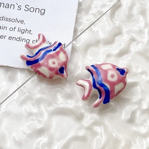 Close-up of pink and blue striped ceramic fish beads for DIY jewelry making