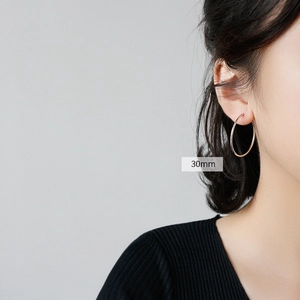Classic S925 sterling silver hoop earrings with 30mm diameter shown on model