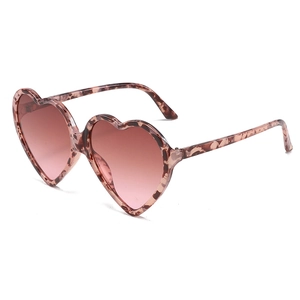 Pink heart shaped sunglasses with tortoiseshell frames shown from a 45-degree angle